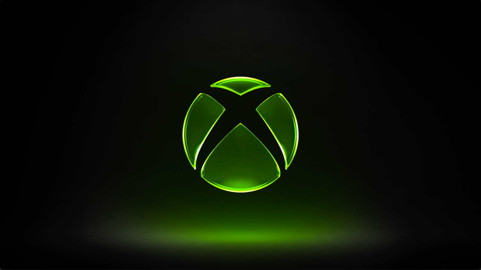 The glowing green Xbox logo on a black background