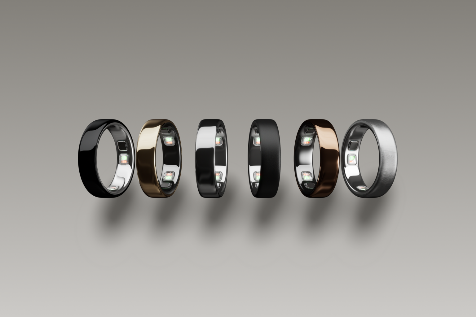 Six Oura Ring 5 finishes lined up on a grey background