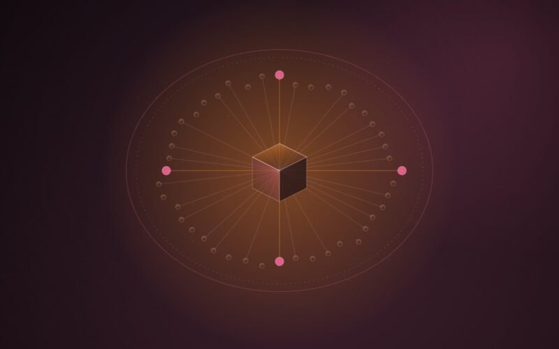 Abstract illustration of a ring of small orange nodes inside a closed oval boundary, with lines converging on an isometric cube at the centre, on a dark burgundy background.