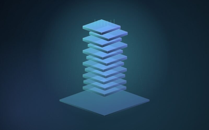 Abstract illustration of a tall stack of glowing cyan and blue memory wafers rising above a thin, dim slab on a dark blue field